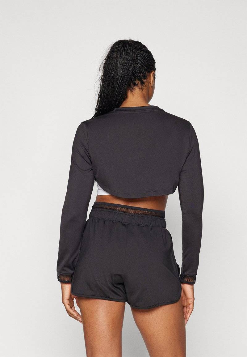 Puma Puma PAMELA REIF CROPPED - Long sleeved top - black 50% Rabatt mit kostenlosem Versand