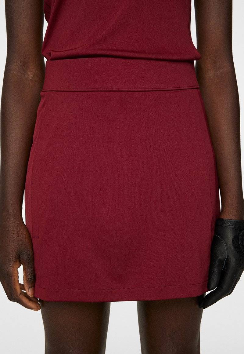 J.LINDEBERG Sports J.LINDEBERG Sports AMELIE MID - Sports skirt - cabernet Versandkostenfrei