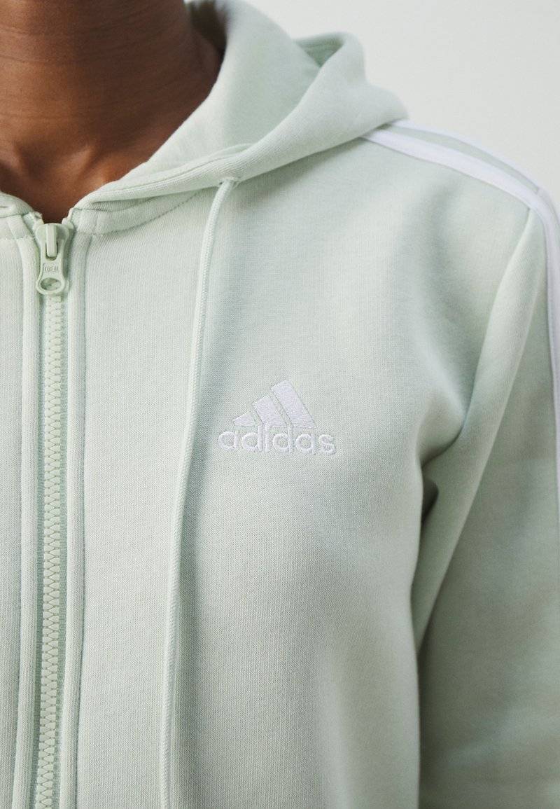 adidas Sportswear adidas Sportswear ESSENTIALS 3 STRIPES FULL ZIP HOODIE - Zip-up sweatshirt - linen green Lagerräumung