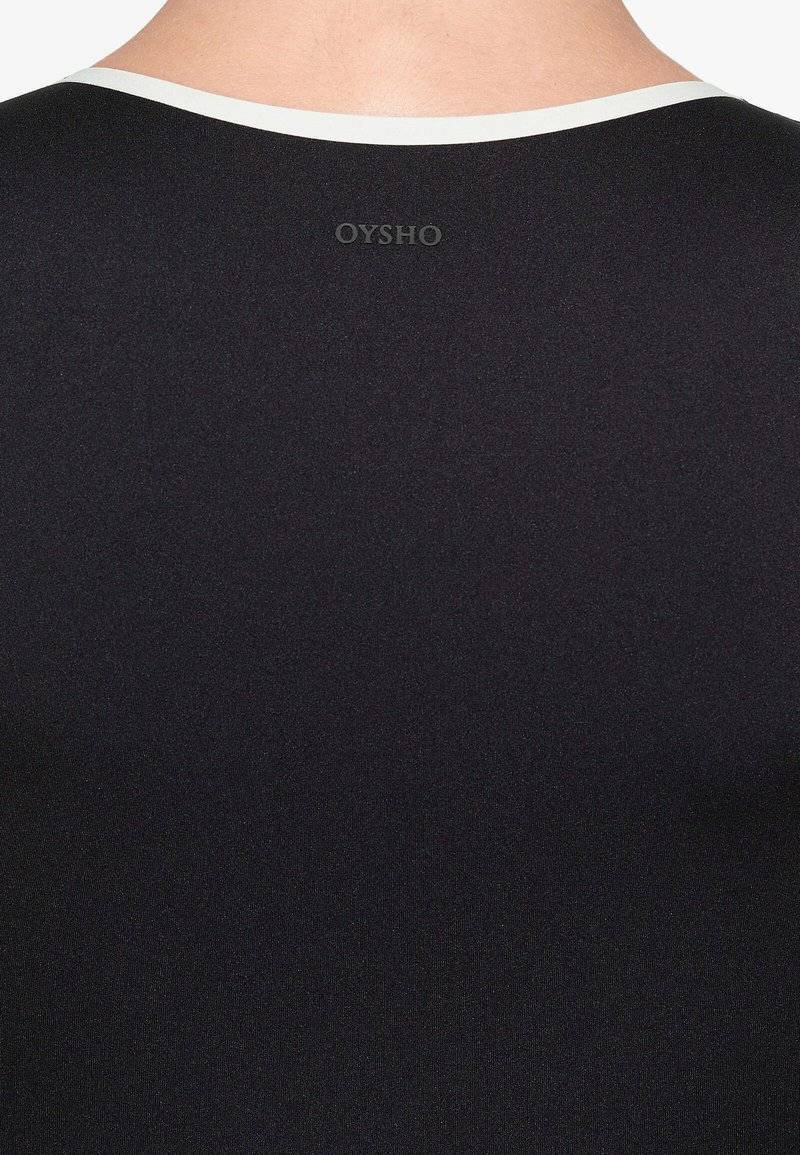 OYSHO OYSHO PERFECT-ADAPT PIPING - Sports T-shirt - black Preisnachlass