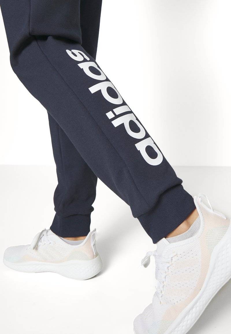 adidas Sportswear adidas Sportswear ESSENTIALS LINEAR CUFFED - Tracksuit bottoms - legend ink Saisonale Angebote